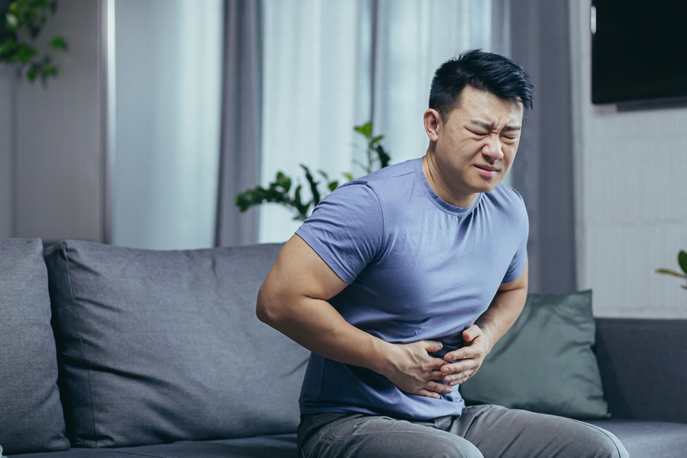 Man holding his abdomen