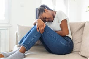 woman holding her abdomen in pain