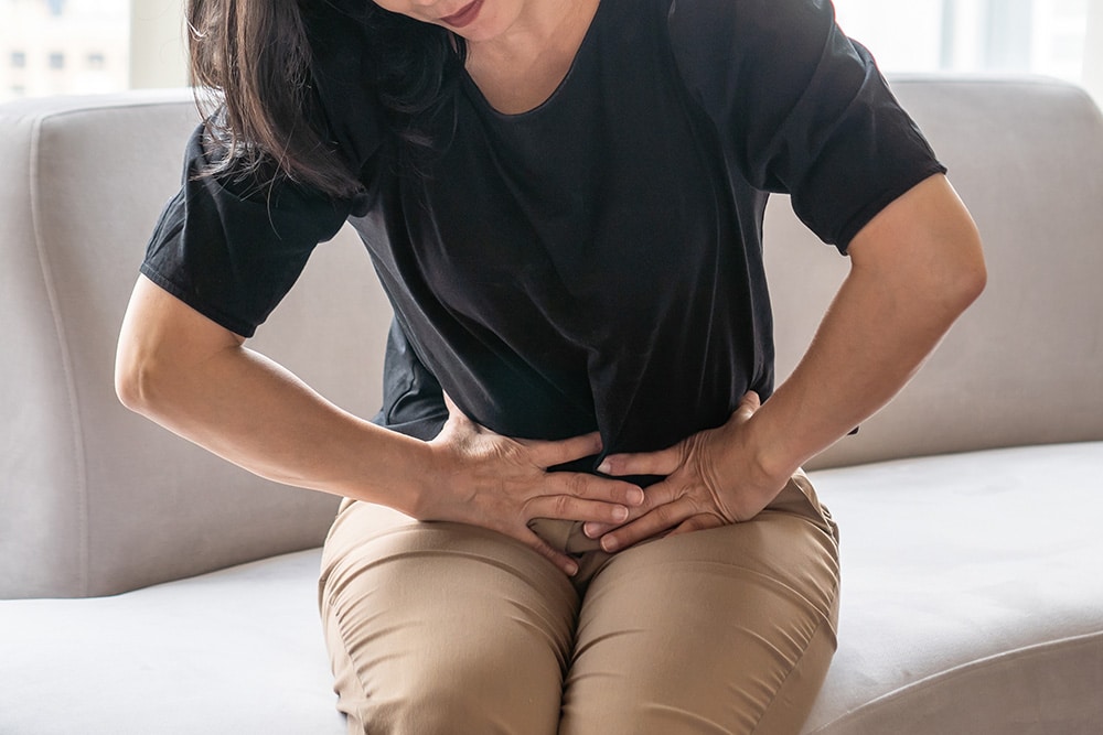 Woman holding abdominal area in pain
