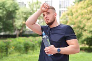 Overheated man with water bottle