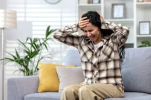 Woman holding her head in pain