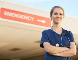 emergency clinic nurse standing infront of an emergency room