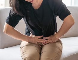 Woman holding abdominal area in pain