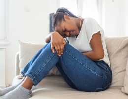 woman holding her abdomen in pain