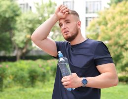 Overheated man with water bottle